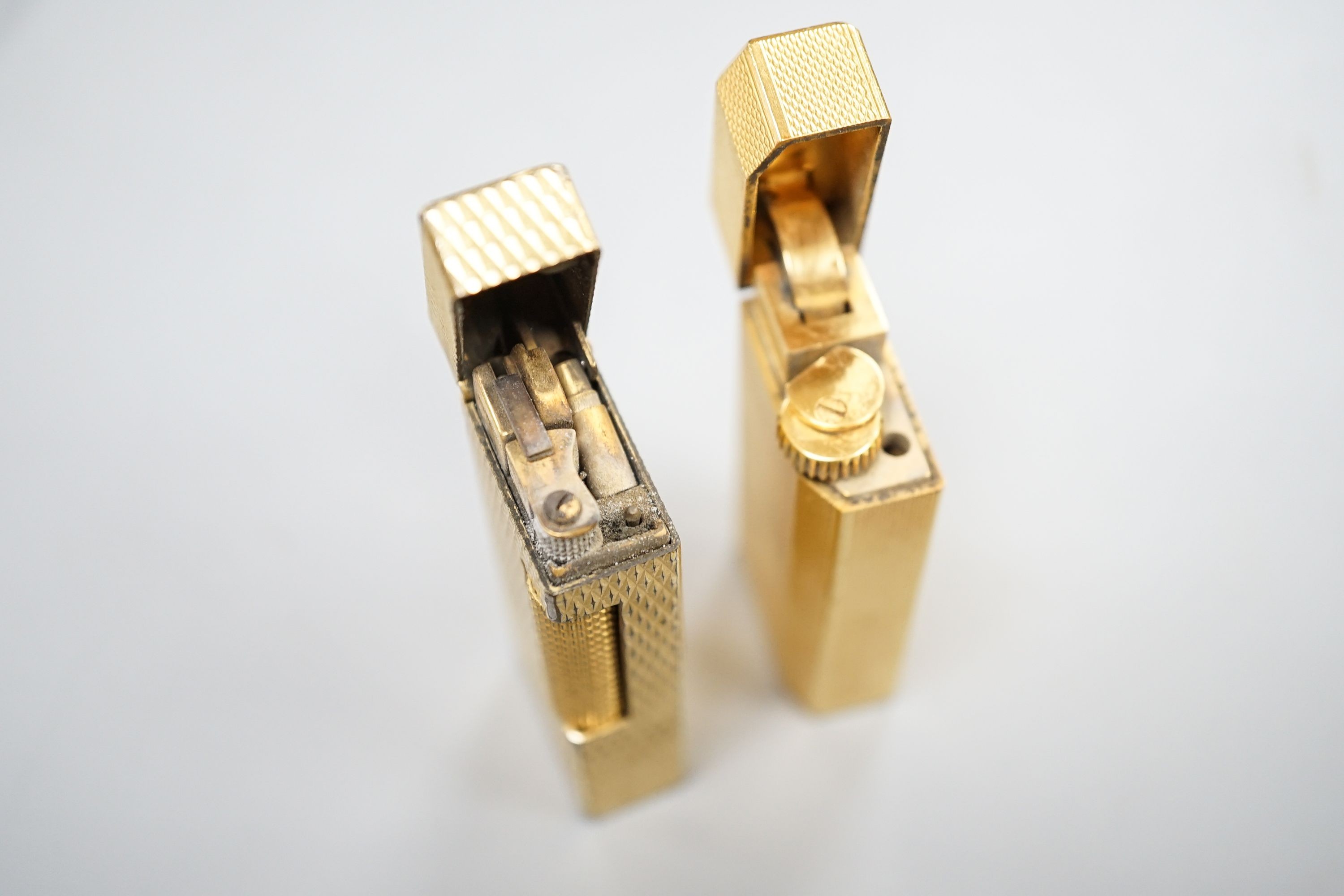 A gold plated Cartier lighter and a similar Dupont lighter